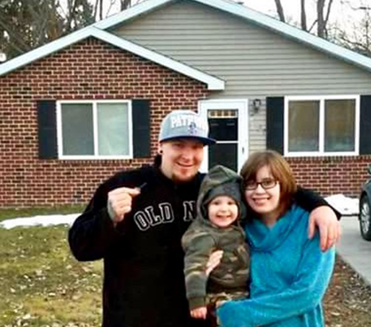 Photo of Mike & Shannon in front of the new home that they were able to purchase with the lump sum they received from liberty settlement funding.